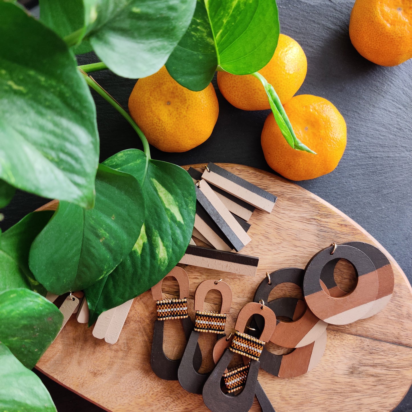 Assortment of handcrafted neutral color statement earrings by the brand SCOTCHBONNET.