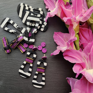 Handcrafted modern, curvy, black and white striped statement earrings with hand-beaded purple accents by the brand SCOTCHBONNET.
