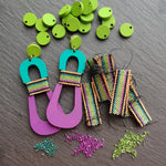 Handcrafted modern, curvy, chartreuse, teal, and purple color blocked statement earrings with hand-beaded accents by the brand SCOTCHBONNET.