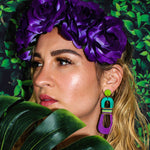 Model wearing modern, curvy, chartreuse, teal, and purple color blocked statement earrings with hand-beaded accents by the brand SCOTCHBONNET.