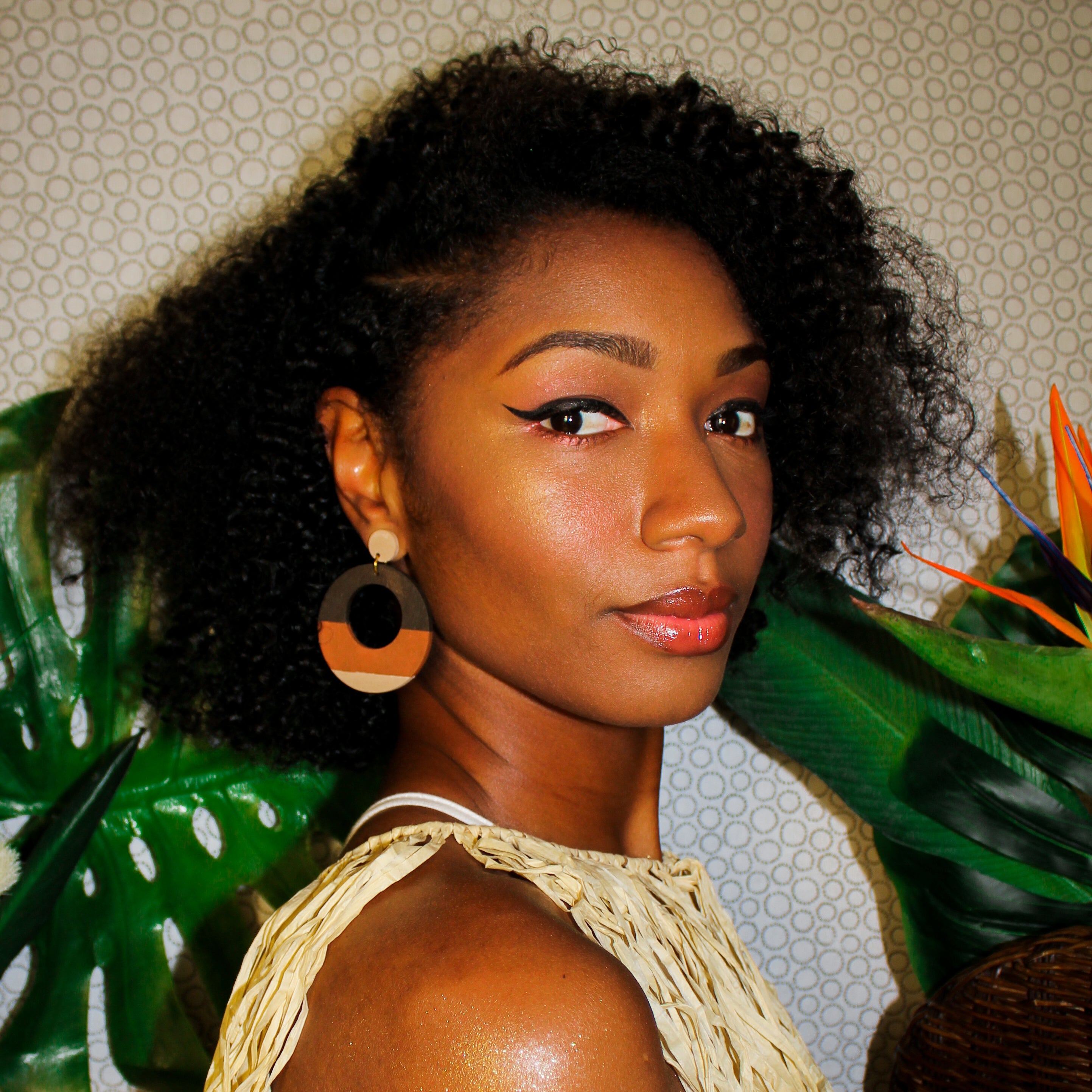 Model wearing large, round, color blocked neutral tone statement earrings by the brand SCOTCHBONNET.