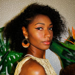 Model wearing large, round, color blocked neutral tone statement earrings by the brand SCOTCHBONNET.