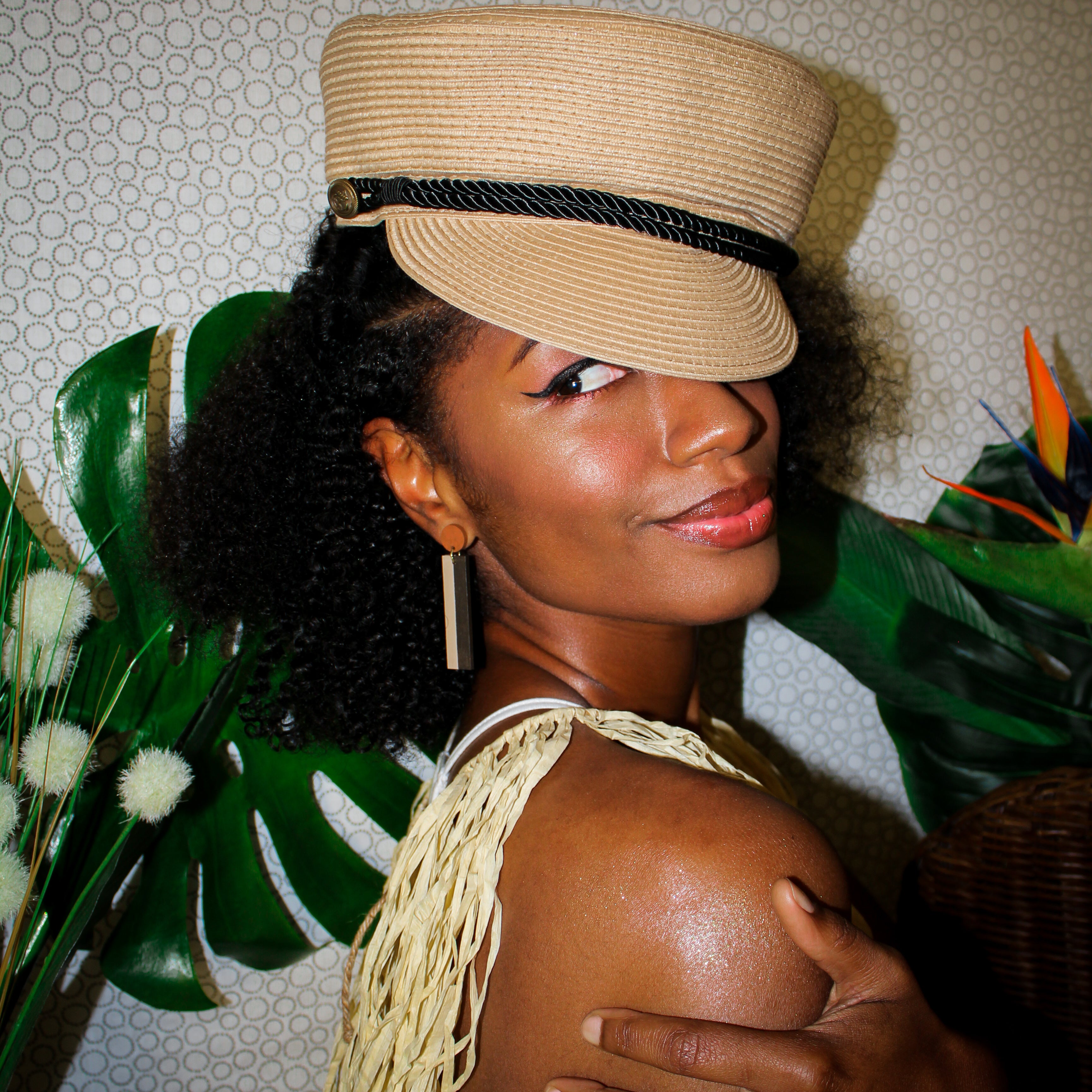 Model wearing geometric color blocked statement earrings in neutral brown shades by the brand SCOTCHBONNET.