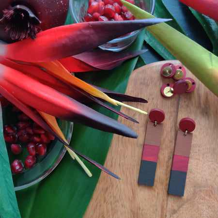 Handcrafted brown, red and dark brown striped geometric earrings by the brand SCOTCHBONNET being assembled.