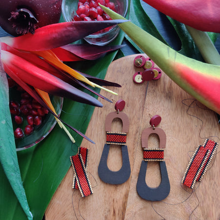 Handcrafted modern, curvy, red, brown, and dark brown color blocked statement earrings with hand-beaded accents by the brand SCOTCHBONNET.