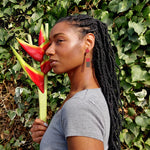 Model wearing brown, red and dark brown striped geometric earrings by the brand SCOTCHBONNET.