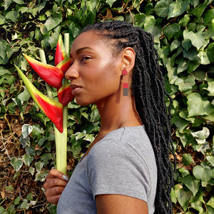 Model wearing brown, red and dark brown striped geometric earrings by the brand SCOTCHBONNET.