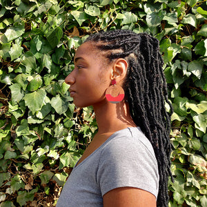 Model wearing large, round, red, brown and dark brown color blocked neutral tone statement earrings by the brand SCOTCHBONNET.