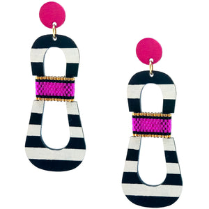 Modern, curvy, black and white striped statement earrings with hand-beaded magenta accents by the brand SCOTCHBONNET.