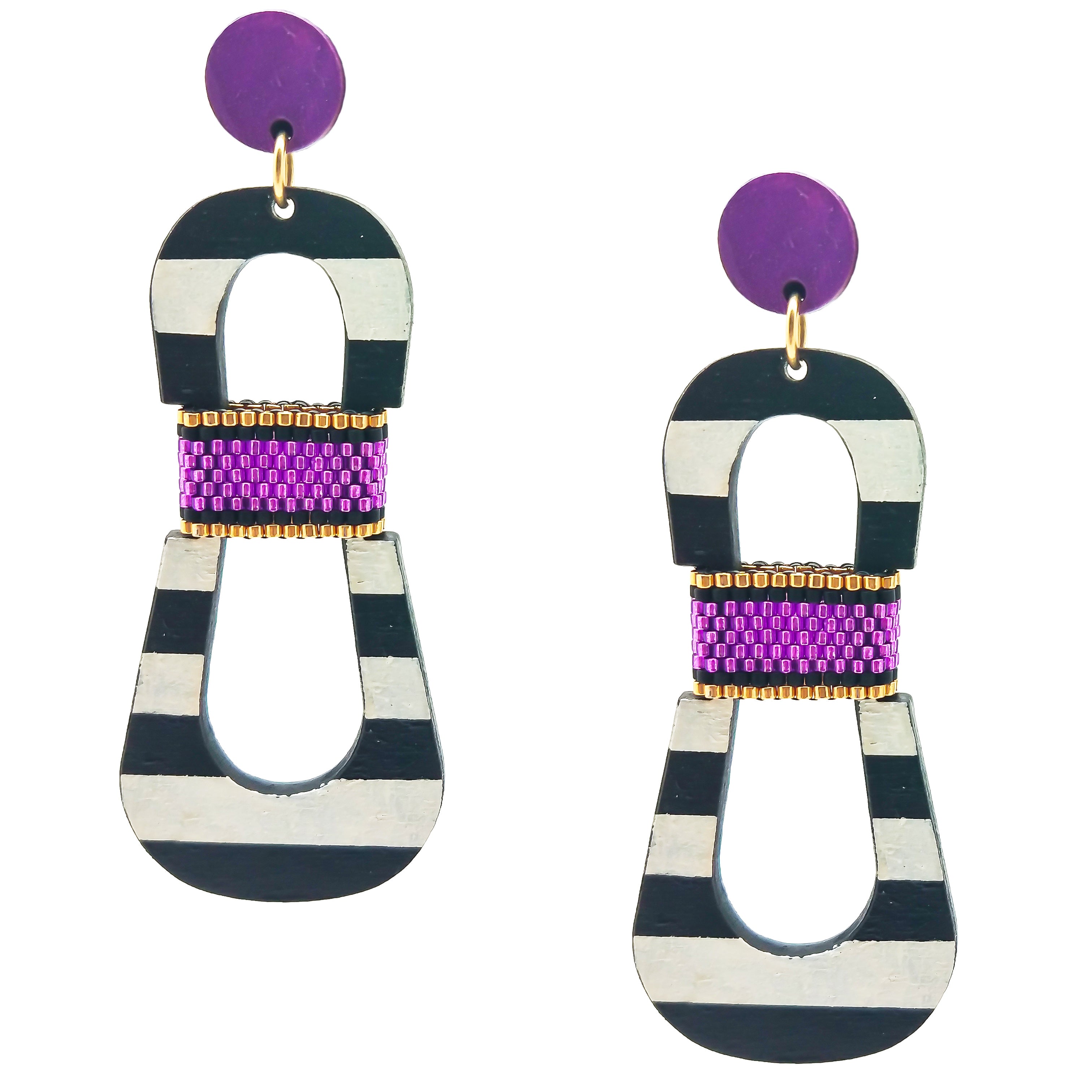 Modern, curvy, black and white striped statement earrings with hand-beaded purple accents by the brand SCOTCHBONNET.