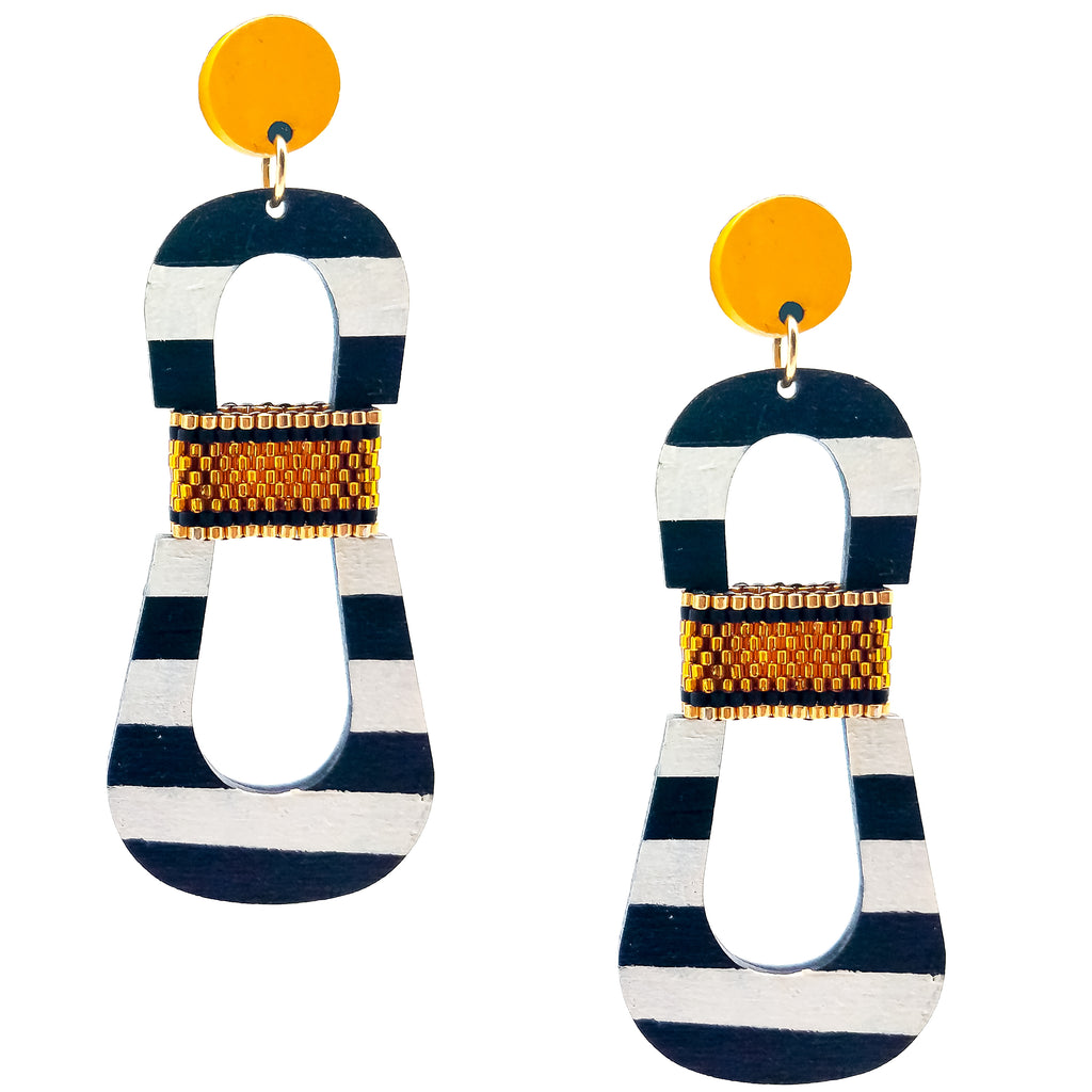 Modern, curvy, black and white striped statement earrings with hand-beaded yellow accents by the brand SCOTCHBONNET.