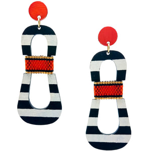Modern, curvy, black and white striped statement earrings with hand-beaded orange accents by the brand SCOTCHBONNET.
