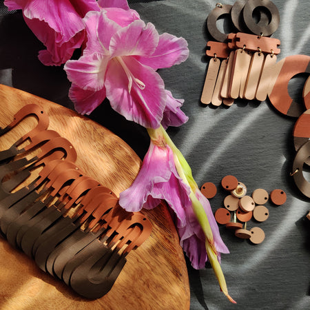 Handcrafted neutral colored earrings by the brand SCOTCHBONNET being assembled.